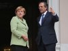 Greece's Prime Minister Antonis Samaras, right, and Germany's Chancellor Angela Merkel speak before their meeting at the Maximos mansion in Athens, Tuesday, Oct. 9, 2012. Amid draconian security measures and a mass protest, German Chancellor Angela Merkel arrived Tuesday for her first visit to Greece since the eurozone crisis began there three years ago. Her five-hour stop is seen by the Greek government as a historic boost for the country's future in Europe, but by protesters as a harbinger of more austerity and hardship.   (AP Photo/Thanassis Stavrakis, Pool)