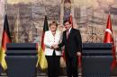German Chancellor Angela Merkel (L) shakes hand with Turkish Prime Minister Ahmet Davutoglu after their meeting on October 18, 2015, in Istanbul