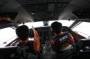 Japan Coast Guard pilots look out from the cockpit of their Gulfstream V Jet aircraft as they search for the missing Malaysia Airlines MH370 plane over the South China Sea