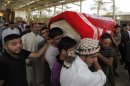 Men carry the coffin of a victim, killed in Friday's bomb attack, during a funeral in al-Rashidiya district of Baghdad