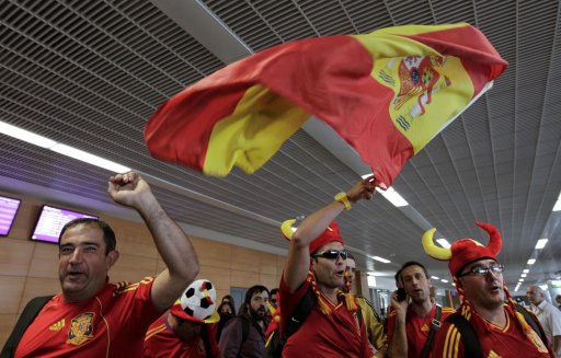 Fans of Spain shout slogans after they arrived at the airport of Donetsk