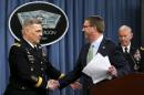 Defense Secretary Ash Carter (R) greets Army General Mark Milley at the Pentagon Briefing Room