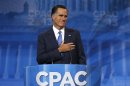 Former Republican Presidential candidate Romney puts his hand to his heart as supporters cheer him upon taking the stage to speak at the CPAC at National Harbor, Maryland