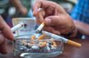 Guests of a coffee shop smoke cigarettes in Vienna on September 9, 2014