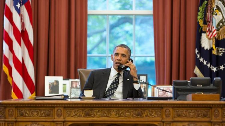This official White House photograph released on September 27, 2013 shows President Barack Obama talks with President Hassan Rouhani of Iran during a phone call in the Oval Office