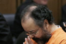 Ariel Castro rubs his nose in the courtroom during the sentencing phase Thursday, Aug. 1, 2013, in Cleveland. Three months after an Ohio woman kicked out part of a door to end nearly a decade of captivity, Castro, a onetime school bus driver faces sentencing for kidnapping three women and subjecting them to years of sexual and physical abuse. (AP Photo/Tony Dejak)