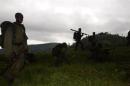 Congolese soldiers advance against the M23 rebels near the Rumangabo military base in Runyoni