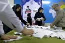 Election officials count ballot papers after the close of polling stations during elections for the parliament and a leadership body called the Assembly of Experts, in Tehran