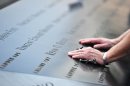 Drew Taylor pauses to remember a New York City fire fighter at the 9/11 Memorial in New York City on September 11, 2013