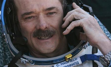 Canadian astronaut Chris Hadfield speaks on the phone after the Russian Soyuz space capsule landed some 150 km (90 miles) southeast of the town of Zhezkazgan, in central Kazakhstan May 14, 2013. REUTERS/Mikhail Metzel/Pool