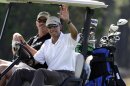 President Barack Obama, right, waves to a crowd of onlookers while driving a golf cart with businessman Glen Hutchins, behind, as they golf at Farm Neck Golf Club in Oak Bluffs, Mass., on the island of Martha's Vineyard, Saturday, Aug. 17, 2013. (AP Photo/Steven Senne)
