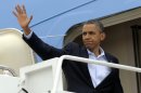 President Barack Obama waves from the steps of Air Force One at Andrews Air Force Base, Md., Sunday, July 22, 2012. Obama is traveling to Aurora, Colo., to visit with families of victims of the movie theater shooting as well as local officials. (AP Photo/Susan Walsh)