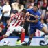 Chelsea's Cahill challenges Stoke City's Owen during their English Premier league soccer match at Stamford Bridge in London