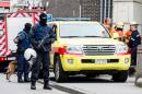 Armed police guard a street in Brussels on Monday, Nov. 16, 2015. A major action with heavily armed police is underway in the Brussels neighborhood of Molenbeek amid a manhunt for a suspect of the Paris attacks. (AP Photo/Geert Vanden Wijngaert)