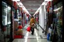 FILE PHOTO - A woman pauses as she shops at a wholesale market in Yiwu