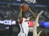 Louisville guard Russ Smith (2) shoots over Michigan guard Nik Stauskas (11) during the first half of the NCAA Final Four tournament college basketball championship game Monday, April 8, 2013, in Atlanta. (AP Photo/Charlie Neibergall)