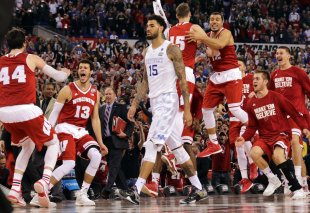 Wisconsin bench celebrates as Kentucky's Willie Cauley-Stein walks off after the loss. (AP)