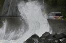 A big sea wave hit against a concrete wall to a road in Kushimoto, western Japan, Saturday, Aug. 9, 2014. Typhoon Halong is lashing Japan as it enters a holiday week, injuring six people and causing authorities to order the evacuation of half a million people near swollen rivers. Japan's Meteorological Agency issued a special warning for heavy rain in Mie prefecture in central Japan, prompting two towns to order about 500,000 residents to evacuate due to a fear of flooding from swollen rivers. The agency said heavy rain in the area would continue overnight. (AP Photo/Kyodo News) JAPAN OUT