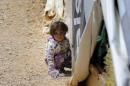 A Syrian child plays at a refugee camp in Lebanon's town of Bar Elias in the Bekaa Valley, on May 13, 2016