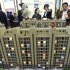 In this April 21, 2012 photo, people check a scale model of a housing project at a real estate fair in Nanjing, in eastern China's Jiangsu province. State media reported Sunday, July 8, 2012, that China's top economic official has ordered local officials to enforce rules aimed at cooling a surge in housing prices. (AP Photo)  CHINA OUT