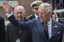 Prince Charles waves to the crowd while crossing a street Wednesday, May 21, 2014 in Winnipeg. The Royal couple are on a four-day tour of Canada. (AP Photo/The Canadian Press, Paul Chiasson)