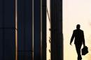 A worker arrives at his office in the Canary Wharf business district in London