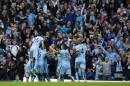 Manchester City's Sergio Aguero, obscured, celebrates with teammates after scoring against Manchester United during their English Premier League soccer match at the Etihad Stadium, Manchester, England, Sunday, Nov. 2, 2014. (AP Photo/Jon Super)