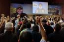 Supporters of Lebanon's Hezbollah leader Sayyed Hassan Nasrallah react as he addresses them from a screen during a ceremony marking the 40th day after Hezbollah commander Mustafa Badreddine was killed in an attack in Syria, in Beirut's southern suburbs