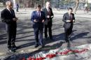 Turkish PM Davutoglu prays as he visits the site of Wednesday's suicide bomb attack in Ankara
