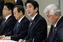 Japanese Prime Minister Shinzo Abe, second right, talks during a ministerial meeting at the prime minister's official residence in Tokyo, Sunday, Feb. 1, 2015 after the release of an online video that purported to show an Islamic State group militant beheading Japanese journalist Kenji Goto. Japan condemned with outrage and horror on Sunday the video posted on militant websites late Saturday Middle East time. Defense Minister Gen Nakatani, right, and Chief Cabinet Secretary Yoshihide Suga, second left, also attend the meeting. (AP Photo/Kimimasa Mayama, Pool)