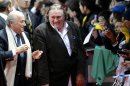 FIFA President Joseph "Sepp" Blatter, left, and French-Russian actor Gerard Depardieu, right, arrive for the FIFA Ballon d'Or Gala 2013 held at the Kongresshaus in Zurich, Switzerland, on Monday, Jan. 7, 2013. French actor Gerard Depardieu has received a Russian passport after he sought Russian citizenship as part of his battle against a proposed super tax on millionaires in France. (AP Photo/Keystone/Walter Bieri)