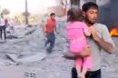 In this image taken from video obtained from the Shaam News Network, which has been authenticated based on its contents and other AP reporting, a Syrian man carries an injured child away from a missile strike in Raqqa, Syria, Wednesday, Aug. 7, 2013. Wednesday's missile attack came after Human Rights Watch said missiles fired by the Syrian army into populated areas have killed hundreds of civilians in recent months. (AP Photo/Shaam News Network via AP video)