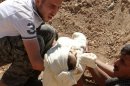 A Shaam News Network picture shows a man carrying the body of a child in Ghouta on August 21, 2013