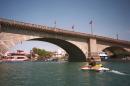 File-This 1997 file photo shows a lone watercraft rider looking under the London Bridge, which spans the Colorado River at Lake Havasu City, Ariz. The London Bridge is not falling down, despite a British tabloid saying that the Lake Havasu City tourist attraction could be bulldozed to make way for drug tourism. Lake Havasu City officials heard about the story in The Sun after a local resident visiting the United Kingdom brought back a copy of the tabloid. They say it was a slap in the face and demanded a retraction and an apology. (AP Photo/Arizona Republic, Thomas Ropp,File) MARICOPA COUNTY OUT; MAGS OUT; NO SALES