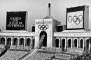 FILE - In this July 28, 1984, file photo, the Olympic flame is flanked by a scoreboard signifying the formal opening of the XXIII Olympiad after it was lit by Rafer Johnson during the opening ceremonies in the Los Angeles Memorial Coliseum. Embarrassing as it was, the U.S. Olympic Committee won't necessarily be remembered for its ungainly dumping of Boston as a bid city for the 2024 Olympics. The USOC has seven weeks to get another city on board _ and it could be Los Angeles. (AP Photo/Eric Risberg, File)
