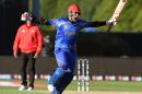 Afghanistan batsman Hamid Hassan celebrates against Scotland in their 2015 Cricket World Cup match in Dunedin, New Zealand on February 26, 2015