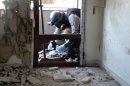 A UN arms expert collects samples on August 29, 2013, from the site of an apparent chemical attack close to Damascus