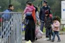 A migrant family walks to a registration center at a Croatia-Slovenia border crossing in Lendava, Slovenia