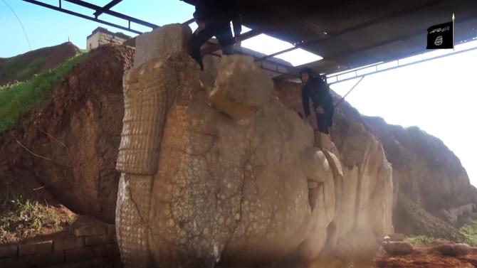 In this image made from video posted on a social media account affiliated with the Islamic State group on Thursday, Feb. 26, 2015, which has been verified and is consistent with other AP reporting, militants destroy winged-bull Assyrian protective deity in the Ninevah Museum in Mosul, Iraq. The extremist group has destroyed a number of shrines --including Muslim holy sites -- in order to eliminate what it views as heresy. The militants are also believed to have sold ancient artifacts on the black market in order to finance their bloody campaign across the region. (AP Photo via militant social media account)