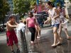 Children play at a fountain on an especially hot day in New York