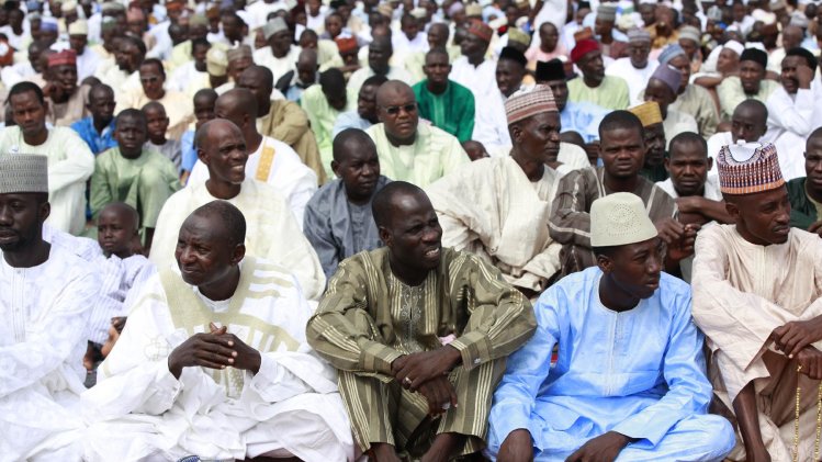 In this photo taken Thursday, Aug. 8, 2013, Nigeria Muslims attend Eid al-Fitr prayers in Maiduguri, Nigeria. Suspected Islamic militants wearing army fatigues gunned down 44 people praying at a mosque in northeast Nigeria, while another 12 civilians died in an apparently simultaneous attack, security agents said Monday Aug. 12, 2013. The slayings occurred Sunday morning at a mosque in Konduga town, some 35 kilometers (22 miles) outside Maiduguri, the capital of Nigeria's Borno state. (AP Photo/Sunday Alamba)