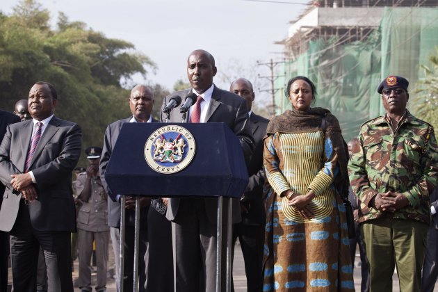 Kenya's Interior Minister Joseph ole Lenku (C), flanked other government officials, speaks during a news conference near the Westgate shopping mall in Nairobi September 25, 2013. Lenku said Thursday U.S., British and Israeli agencies are helping Kenya investigate an attack by Islamist militants on Westgate shopping mall that killed at least 72 people and destroyed part of the complex. REUTERS/Siegfried Modola (KENYA - Tags: CIVIL UNREST CRIME LAW)
