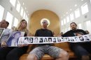 Israelis hold pictures of their family members who were killed by Palestinians during a protest against the release of Palestinian prisoners, in Jerusalem