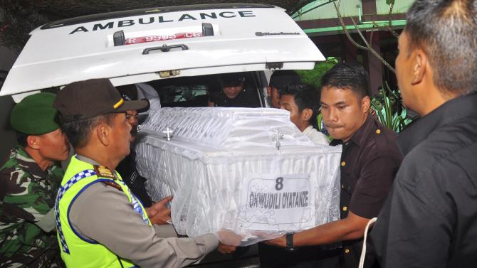 Members of Indonesian security carry the coffin containing the body of executed Nigerian Okwudili Oyatanze at an orphanage in Semarang regency, Central Java, Indonesia