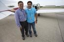 In this Thursday, June 19, 2014 photo, Babar Suleman and son Haris Suleman, 17, stand next to their plane at an airport in Greenwood, Ind. before taking off for an around-the-world flight. On Wednesday, July 23, 2014, a single-engine plane with two aboard crashed in waters off American Samoa, with a registration number matching the plane flown by the Indiana teen attempting to fly around the world in 30 days. (AP Photo/The Indianapolis Star, Robert Scheer)