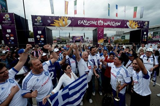 Greek fans shout slogans outside the fanzone of Warsaw