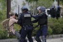 French police apprehend a youth during a demonstration to protest the government's proposed labor law reforms in Nantes