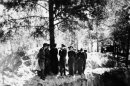 FILE - In this May 1943 file photo, a group of American and British POWs being held by the Germans, including Lt. Col. John H. Van Vliet Jr. and Capt. Donald B. Stewart, look over a mass grave where murdered Polish officers are buried, near Smolensk, Russia. The Soviet secret police killed the Poles in 1940, hoping to eliminate an elite that would have resisted Soviet control of Poland. Van Vliet and Stewart were among a group of British and American prisoners forced to see the horrifying site by the Germans, who wanted word to get out to the world of the Soviet atrocity. Newly declassified documents being opened to the public on Monday, Sept. 10, 2012, by the U.S. National Archives show that Van Vliet and Stewart sent coded messages to Washington after their visit saying they believed the German account of Soviet guilt. It is credible evidence that Washington had relatively early on, but of which it still chose to ignore in order not to jeopardize the alliance with Joseph Stalin. (AP Photo/File)