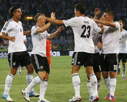Germany's Gomez celebrates with Khedira, Schweinsteiger and Podolski after he scored a goal against Netherlands during their Euro 2012 Group B soccer match at the Metalist stadium in Kharkiv