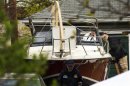 Members of the FBI Evidence Recovery Team inspect the boat where Boston Marathon bombing suspect Dzhokhar Tsarnaev was hiding at 67 Franklin St. in Watertown, Massachusetts